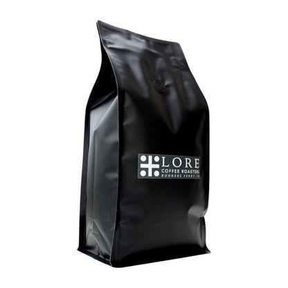 Black coffee bag with 'LORE Coffee Roasters' logo on a white background