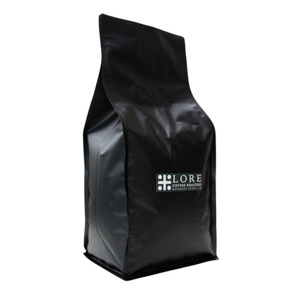 Black coffee bag with 'LORE Coffee Roasters' logo on a white background